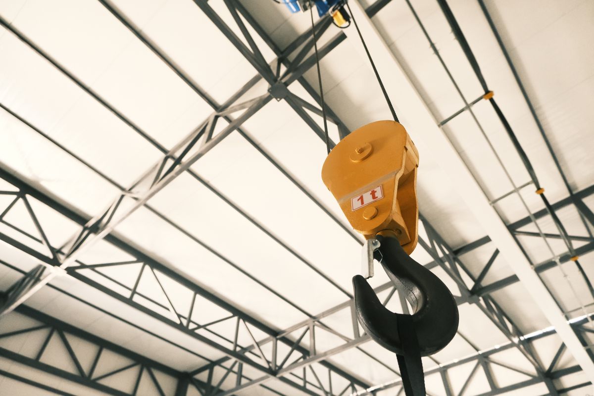 Yellow crane hook in an industrial facility