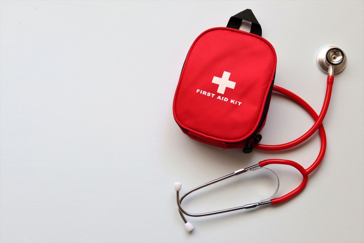 Red first aid kit and stethoscope