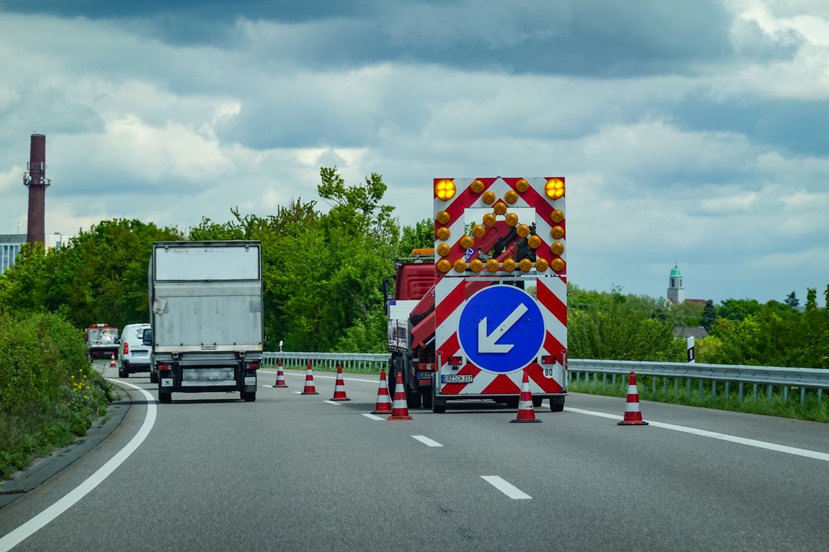 Highway maintenance with cones and warning signs